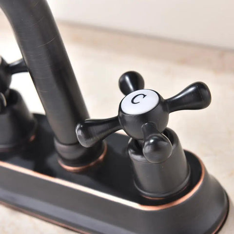 Close-up of Oil Rubbed Bronze Bathroom Faucet With 2 Handles 4 Inch Centerset Vanity Sink Faucet Stainless Steel Farmhouse Deck