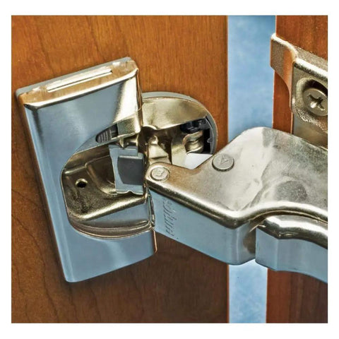 Close-up of installed hinge angle restriction clip for Clip Top soft close hinges, 86 degree opening, on wood cabinet door.