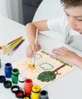 Child painting on Kickass 18 Pack Premium Basswood Sheets 6 By 6 Inch One Sixteenth Thick Wood Panels for DIY crafts.