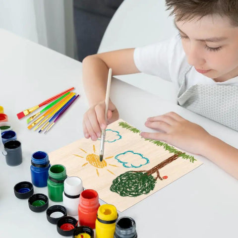 Child painting on Kickass 18 Pack Premium Basswood Sheets 6 By 6 Inch One Sixteenth Thick Wood Panels for DIY crafts.