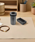Heavy Lifter Graphite Crucible And Metal Smelting Mold Set With Integrated Oil Traps on a workspace for jewelry making.