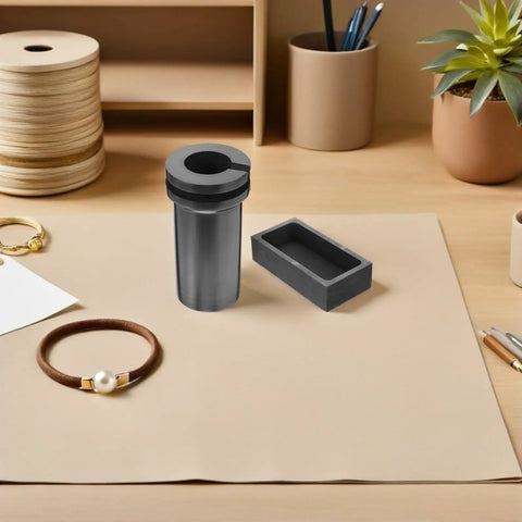 Heavy Lifter Graphite Crucible And Metal Smelting Mold Set With Integrated Oil Traps on a workspace for jewelry making.