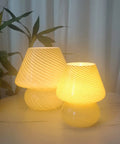 Swirl Mushroom Glass Lamp In Striped Pink, Hand Blown Translucent Murano Style Table Bedside Light on table glowing warmly