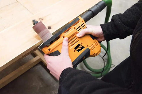 Person using Heavy Duty 650W Portable Oscillating Spindle Sander for smooth edge sanding on wood surface.