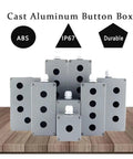 Front view of multiple cast aluminum push-button switch boxes with 22 mm knockouts, IP67 rating on gray enclosures.