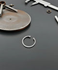 Close-up of a C-shaped elastic snap ring from Five Piece Stainless Steel Retaining Clips Internal Snap Rings Assortment Kit for DIY use.