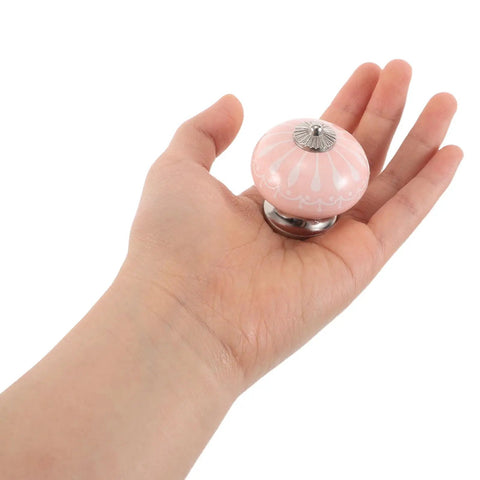 Person holding a blush ceramic drawer handle from 4 Pack Handcrafted Blush Ceramic Drawer Handles For Dresser And Kitchen Cabinets Single Hole Vintage Cabinet Knobs For Wardrobe And Furniture Pulls Rustic Style Easy Grip Pulls For Cabinets