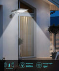 Outdoor solar motion sensor wall light illuminating house facade at night with 600lm brightness and 120° sensing angle.
