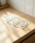 Upgraded Heavy Duty Nano Acrylic Gel Small Clear Adhesive Hooks 36 Pack Damage Free Mini Wall Hangers on wood surface.