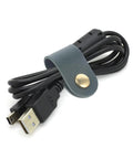 Premium Faux Leather Cable Organizer Straps For Earphones And Usb Cables, dark green strap securing USB cable for travel.