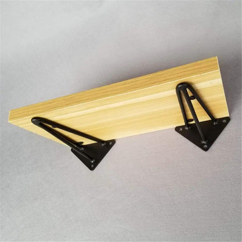 Built Tough Heavy Duty Rustic Shelf Brackets Wall Mount Supports Sturdy Triangle Steel Corbels with wood plank and black brackets.