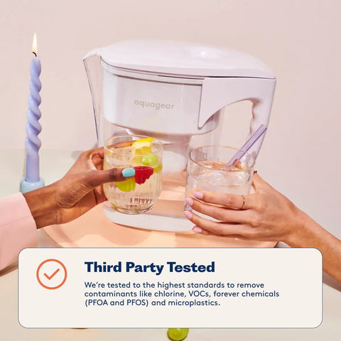 Water Filter Pitcher That Kicks Contaminants To The Curb, Removing Lead, Chlorine, Microplastics, PFOA PFOS, 20x More Contaminant Removal shown on a table with two glasses.
