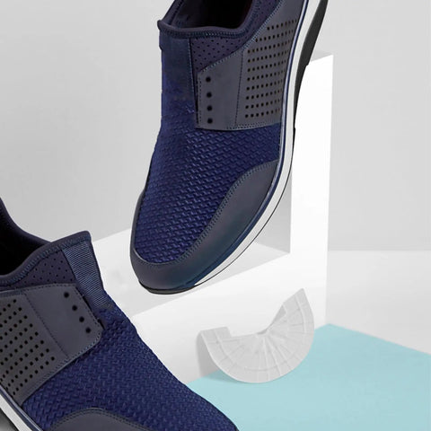 Rubber Shoe Heel Repair Pads 4mm White 1 Pair on blue background next to navy sneakers with textured surface.