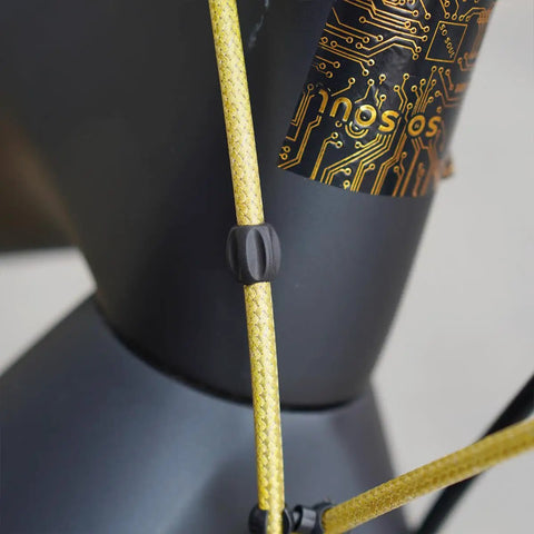Close-up of gold braided housing on Shifter Cable Set with Braided Housing and Teflon Coated Inner Wire for Road and Mountain Bike Derailleurs