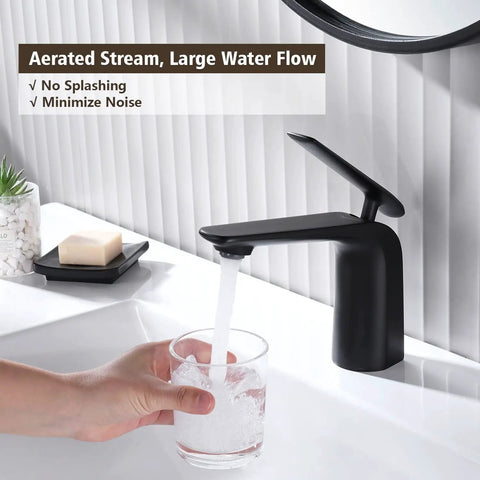 A hand holding a glass under Matte Black Bathroom Sink Faucet With Single Handle, Deck Mount 1 Hole, Brass Body pouring water.