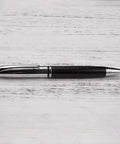 Rotary 0.5mm Ballpoint Pen Set with Leather Grip, Metal Body and Smooth Gel Ink, pen placed on wooden surface