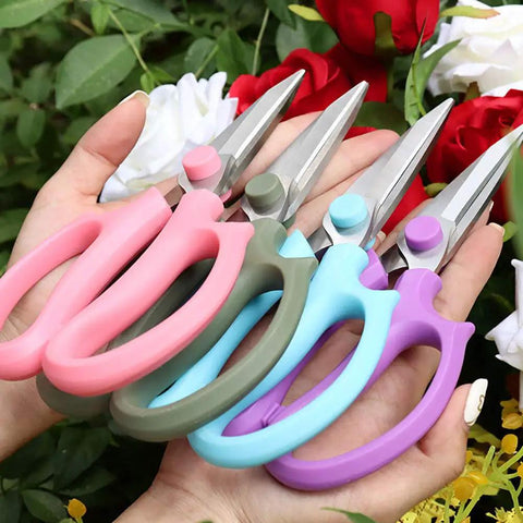 Pro Grade Floral Shears For Flowers And Garden Pruning, Heavy Duty High Carbon Steel Pruner held in hands among roses