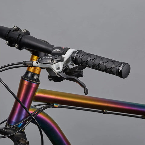 Double Lock On Mountain Bike Grips With Anti Slip Shock Absorbing Rubber For Vibration Dampening And All Day Comfort On Any Trail Black With Locking Rings installed on colorful MTB handlebar.