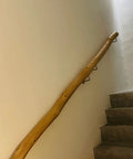 Heavy Duty Solid Wood Stair Handrail Featuring All Weather Non Slip Grip Eight Foot wall mounted railing along staircase wall.
