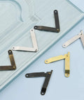 Bronze Antique Lid Support Hinges Set for Jewelry Boxes, Wooden Chests, Cabinets and Furniture, on wooden surface