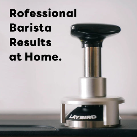 Pro Grade 58.5mm Espresso Tamper With 25Lb Constant Pressure Spring Loaded System on countertop, silver and black design.