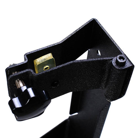 Close-up of a metal rear high lift jack mount carrier for 2007-2017 Jeep Wrangler JK showing bolt-on design and hinge attachment.