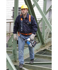 Super Lightweight Portable Magnetic Drill Press By CS Unitec MAB 100 K Compact Cordless Unit Just Weighs 21.8 lbs being carried by a worker on-site.