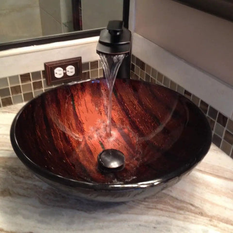 Cascade Waterfall Vessel Faucet With Single Lever Handle, Oil Rubbed Bronze Finish, flowing water into a vessel sink