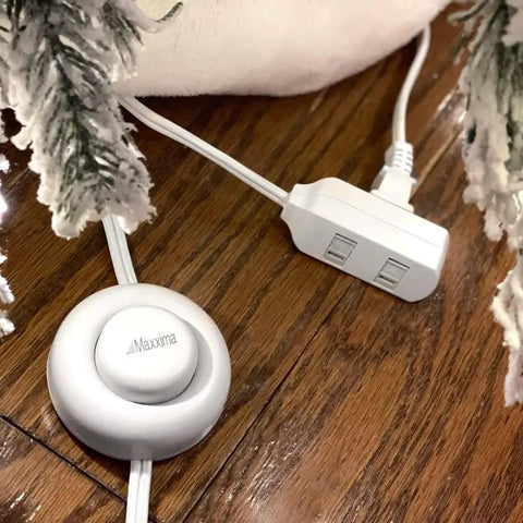 Nine Foot Three Outlet Extension Cord With Foot Switch Lets You Tap Lamps Appliances And Lighting On Or Off Perfect For Senior Living 125VAC White Pack Of Two shown on a wooden floor near snowy decor
