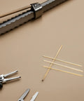4 Piece Solid Brass Rod Kit For DIY Makers And Craft Projects Polished Round Brass Bars on Craft Table with Tools