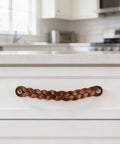 Braided Leather Drawer Pulls in Cognac Finish, 2 Pack, Measures 7-7/8 inches long by 1 inch wide, installed on kitchen drawer.