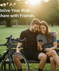 Couple sitting on a bench reviewing data on phone after using 4K Bike Camera With GPS Tracking And Integrated Cycling Computer Headlight