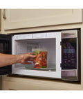 Person placing 32 Oz Deli Style Food Storage Container with lid in microwave, highlighting microwaveable Leak Proof BPA Free plastic use.