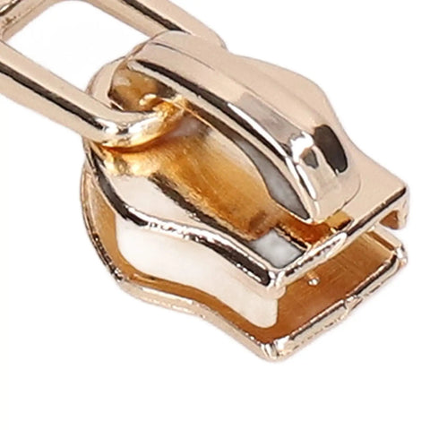 Close-up of a light gold zipper slider from the 5 Piece Zipper Sliders Set For Quick On The Go Fixes Detachable Reusable Zipper Pulls Replacement Kit.