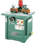 Straight Up 5 Hp Spindle Shaper With Three Quick Swap Arbors And Four Sick Speed Settings Built Tough For Heavy Duty Routing and Custom Woodworking Buildouts, green machine with controls and arbors.