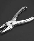 One Handed Hole Punch For Paper, 6 Sheet Capacity, 3.175mm Hole, Chrome Plated Handheld Puncher With Scrap Collector on dark background