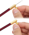 Close-up of Tambour Hook Kit With 3 Interchangeable Needle Heads 0.7mm 1.0mm And 1.2mm, red metal handle with gold accents