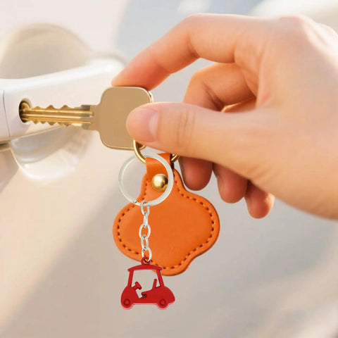 Hand holding car key with red golf cart zinc alloy keychain, part of Two Piece Golf Keychains Set In Zinc Alloy Durable Golf Cart Key Ring