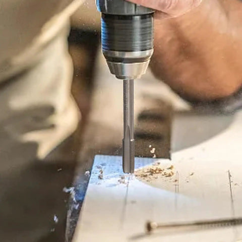 Five Sixteenth By Thirty Six Right Hand Thread Tap for metalworking in a drill, machining steel surface.