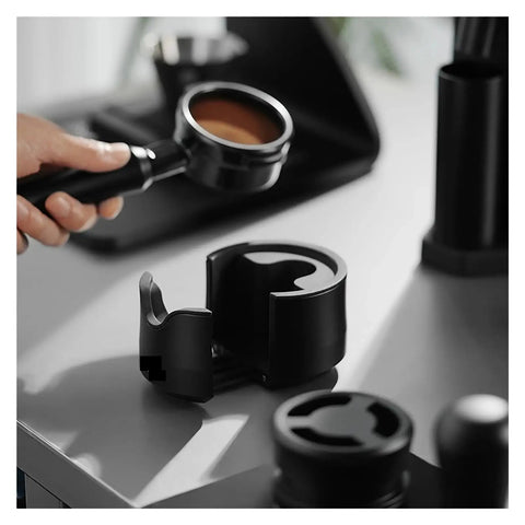 Adjustable Portafilter Holder And Tamping Base For Espresso Machine showing portafilter holder on gray bench.