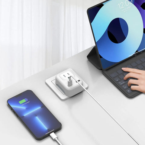 4 In 1 European Travel Plug Adapter with US Outlet and USB Ports charging phone and tablet on desk, compact white charger