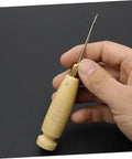3 Piece Awl Handle Set For Leather Crafting And Woodworking With Ergonomic Wooden Grip showing a wooden awl in hand.