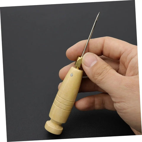 3 Piece Awl Handle Set For Leather Crafting And Woodworking With Ergonomic Wooden Grip showing a wooden awl in hand.