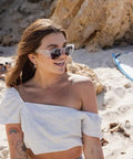 Kickass Polarized Safety Glasses Featuring Rounded Retro Frames And Anti Scratch Coatings Osha Approved Ansi Certified UV400 Polycarbonate Protective Eyewear Totally Dope For Working Men worn by woman at beach.