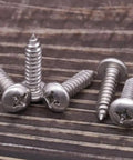 Heavy Duty Tough As Nails 304 Stainless Steel Pan Head Sheet Metal Screws Phillips Drive Self Tapping Rust Resistant Hardware For Wood And Metal Projects Pack Of Fifty on a wooden surface.