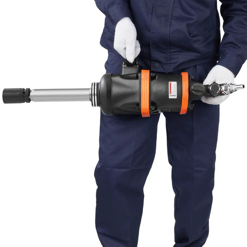 1 Inch Air Impact Wrench With Extended Anvil Knocking Out 5175 Ft Lbs Of Beast Mode Torque For Heavy Duty Truck Bus Tractor And Machinery Repairs Designed To Tackle Any Job Without Breaking A Sweat, held by a technician.