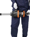 Heavy Duty Air Impact Wrench 1 Inch held by worker, showing aluminum body and extended anvil for tire work and maintenance.