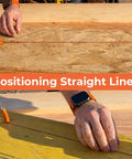 Close-up of Portable Chalk Line Anchor Tool securing rope on wooden surface for carpentry, showing one-handed operation.