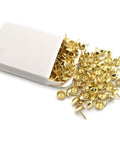 Top Shelf Gold Mushroom Upholstery Tacks For Furniture Nails And Diy Craft Projects Hella Smooth Polish With Rock Solid Iron Build Badass Accent Details 100 Piece Sweet Vibe Set in a white box with scattered tacks.