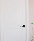 Quiet Operation Matte Black Door Lever Handle With Silent Technology And Wave Style Privacy Lock on white door